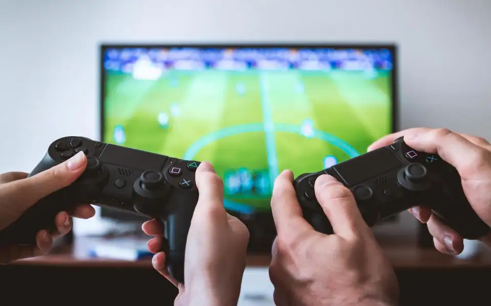 Game controllers and a match on screen, representing the variety of 218PLUSPH games
