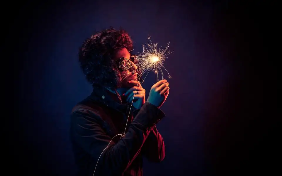 Player holding a sparkler to celebrate 218PLUSPH promotions