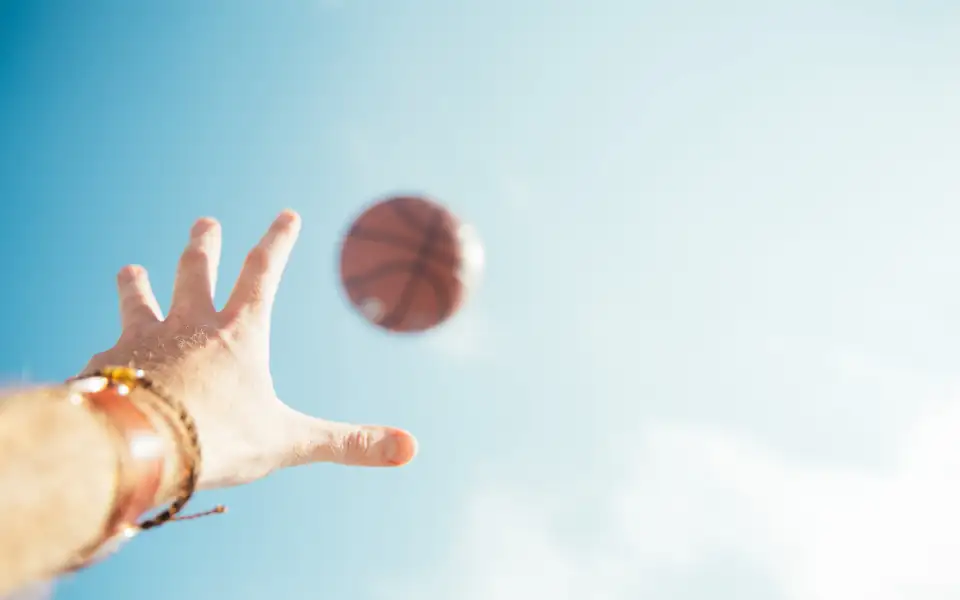 Basketball in the air representing 218PLUSPH sports betting on PBA and NBA